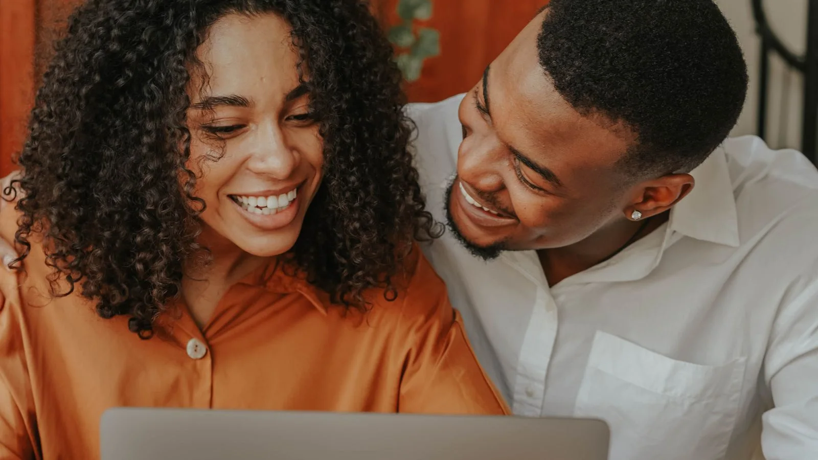 A couple sharing their home details online from their kitchen