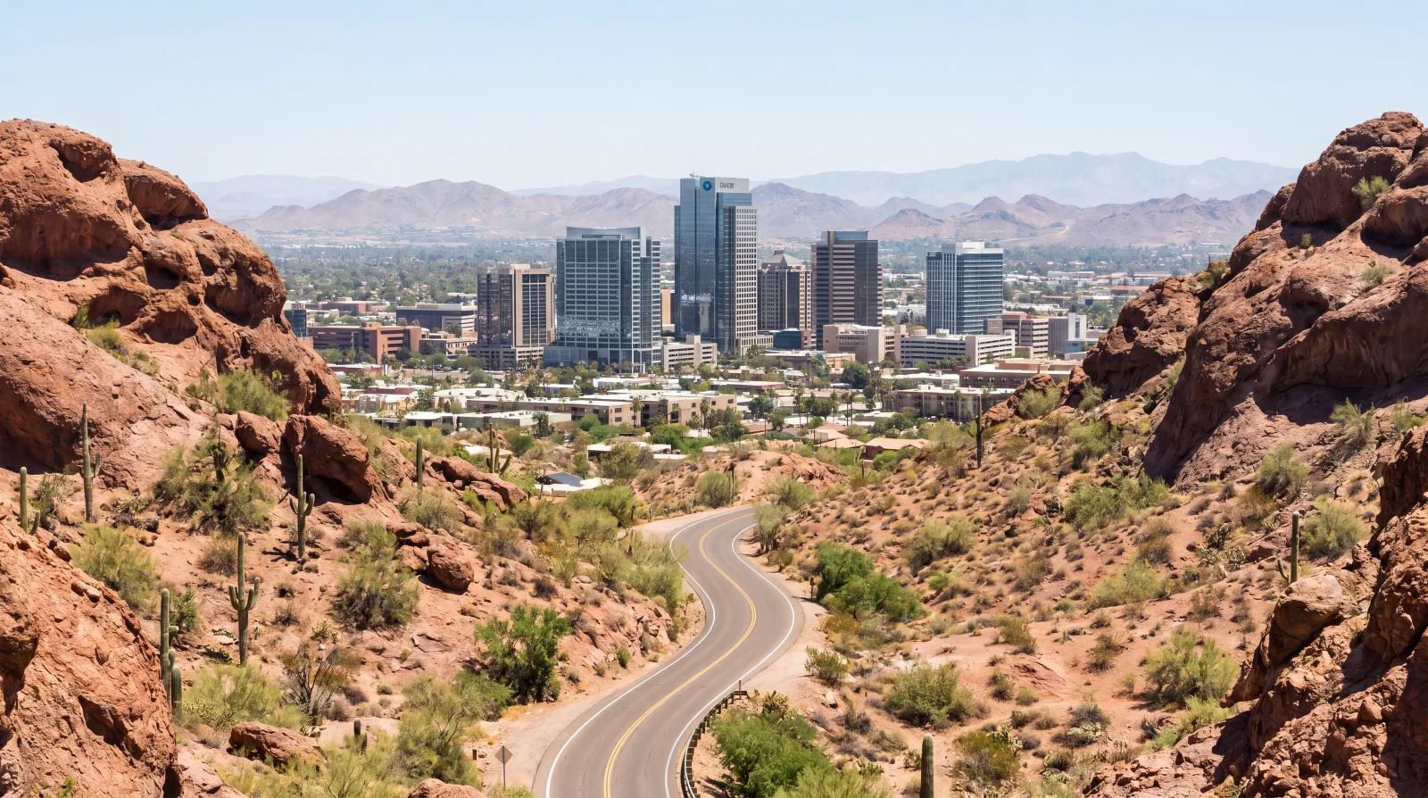 The downtown Phoenix skyline framed by the red rock buttes of the Valley